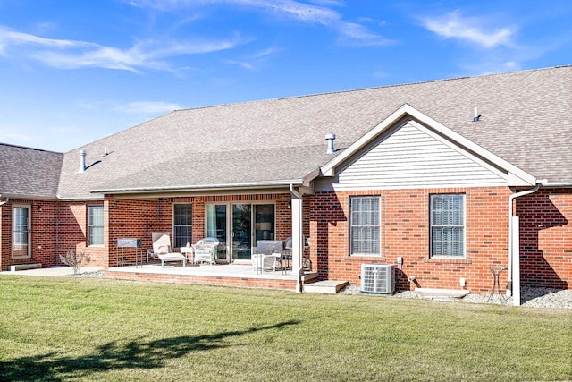 back of property with a yard, central AC, and a patio area