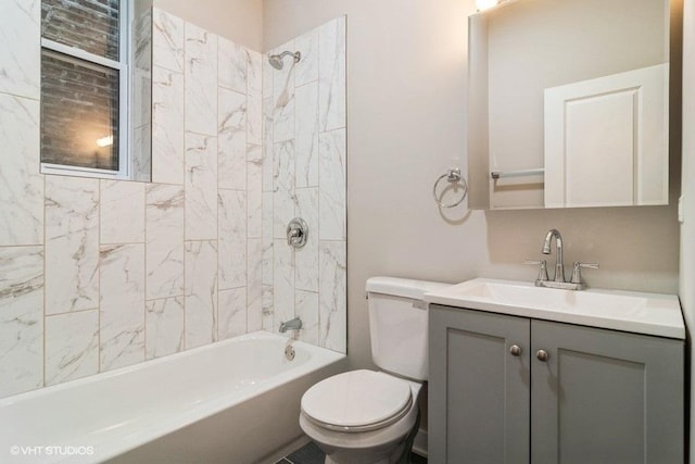 full bathroom with tiled shower / bath, vanity, and toilet