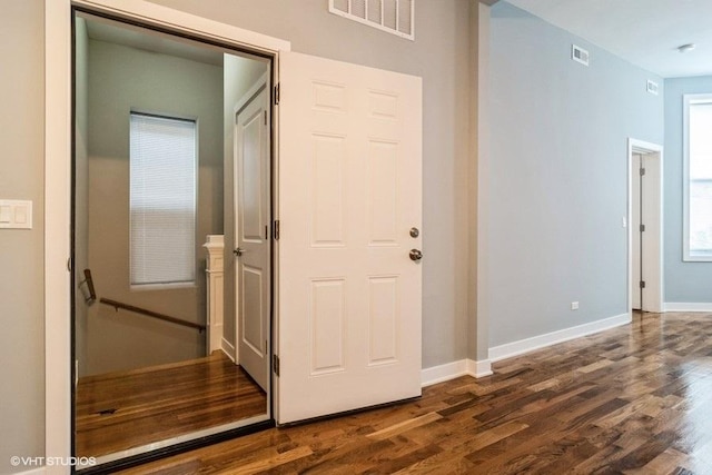 corridor featuring dark wood-type flooring