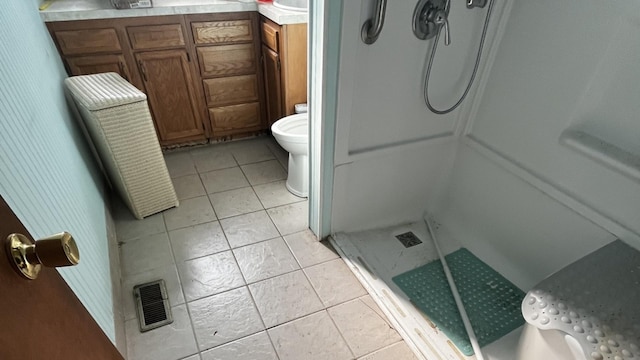 bathroom with toilet, vanity, tile patterned floors, and walk in shower