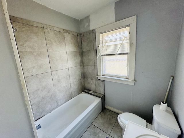 bathroom featuring tile patterned floors, toilet, and a wealth of natural light