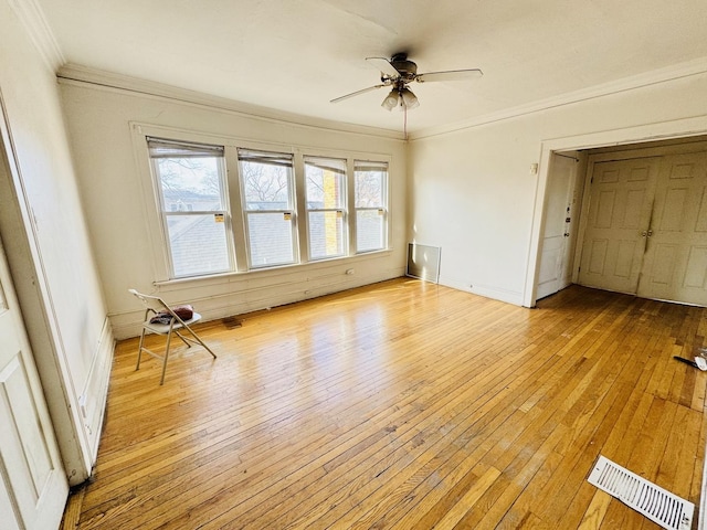 interior space with ornamental molding, a healthy amount of sunlight, and light wood-type flooring