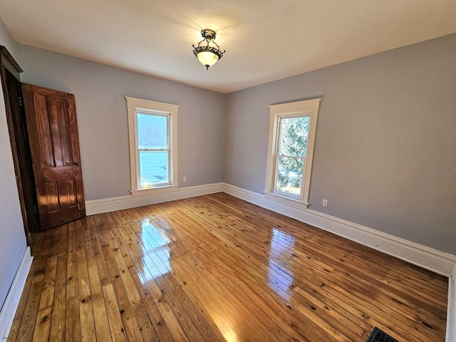 spare room with hardwood / wood-style floors