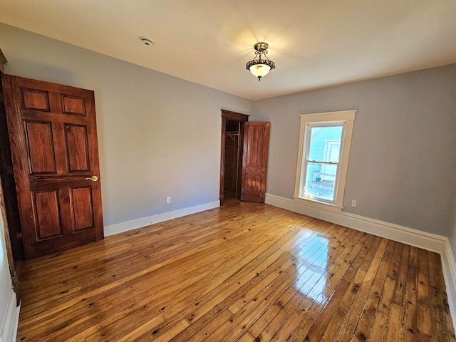 unfurnished bedroom with a closet and light hardwood / wood-style flooring