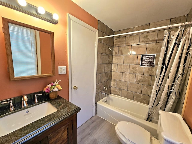 full bathroom featuring hardwood / wood-style flooring, vanity, shower / bathtub combination with curtain, and toilet