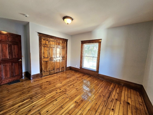 unfurnished bedroom with hardwood / wood-style floors