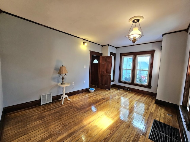 foyer featuring hardwood / wood-style flooring and ornamental molding