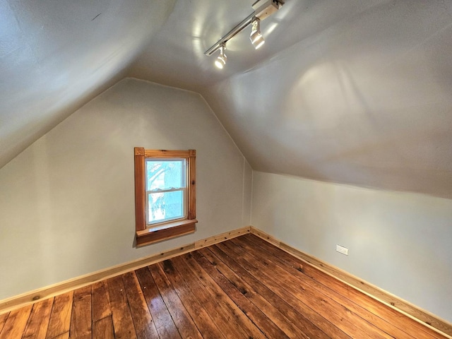 bonus room featuring vaulted ceiling and hardwood / wood-style floors