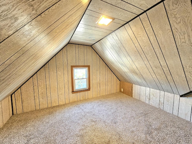 bonus room featuring vaulted ceiling, wooden ceiling, wooden walls, and carpet flooring