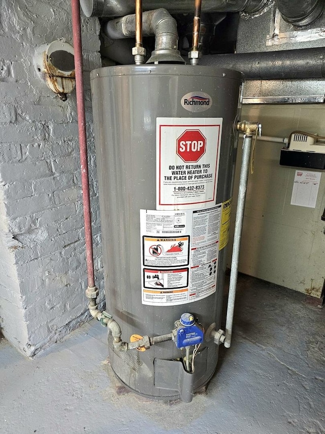 utility room featuring gas water heater