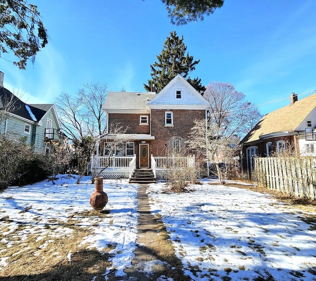 view of snow covered back of property