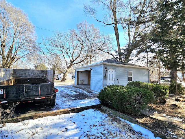 snow covered property with a garage