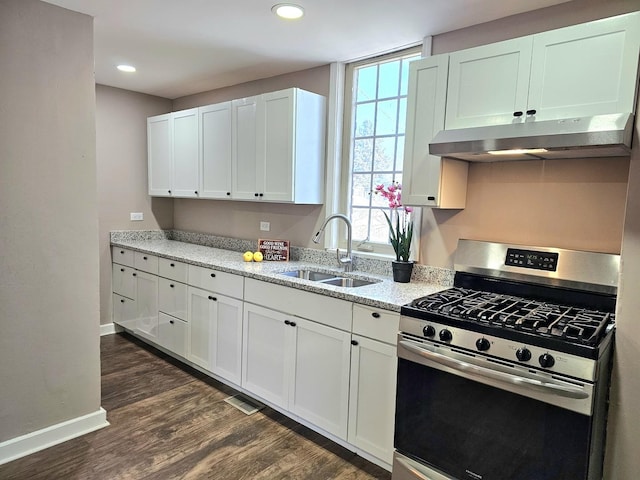 kitchen with dark wood-type flooring, sink, white cabinetry, light stone counters, and stainless steel range with gas cooktop