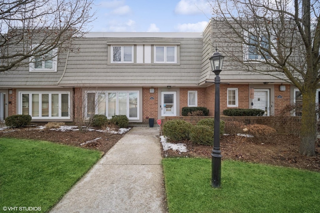 view of property featuring a front lawn