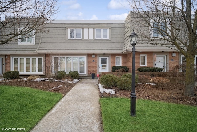 view of property featuring a front lawn