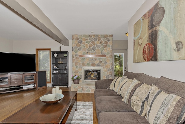 living room featuring a fireplace, hardwood / wood-style floors, and beam ceiling