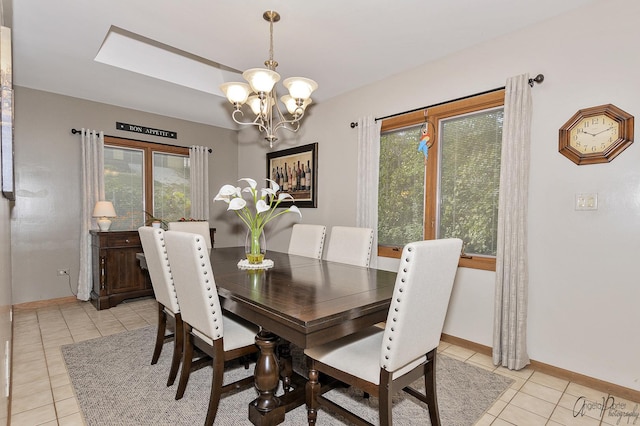 tiled dining area featuring an inviting chandelier