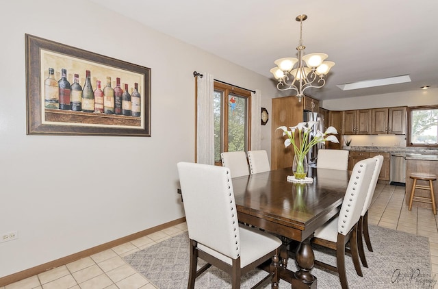 dining space with light tile patterned floors, a wealth of natural light, and a chandelier