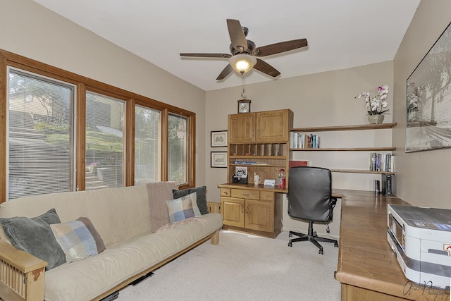 office space with ceiling fan, light colored carpet, and a healthy amount of sunlight