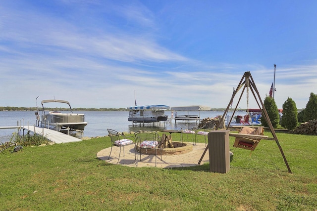 view of dock with a water view and a lawn