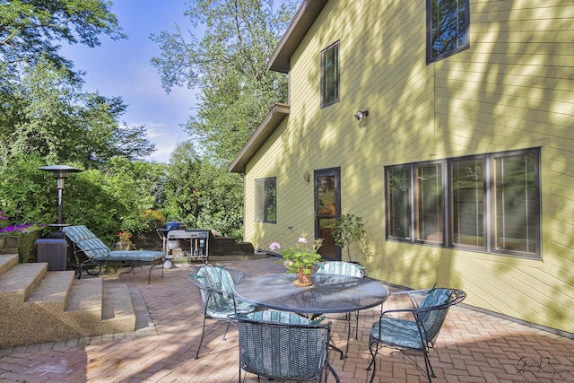 wooden terrace featuring a patio area