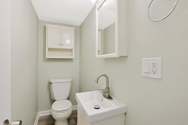 bathroom featuring hardwood / wood-style flooring, toilet, and sink