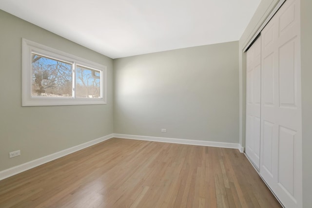 unfurnished bedroom with light hardwood / wood-style floors and a closet