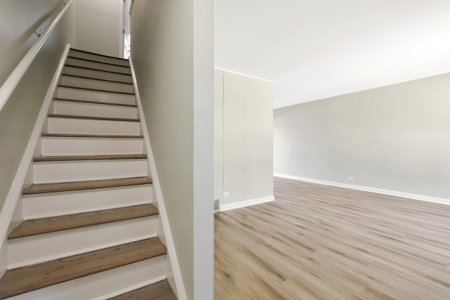 stairway featuring wood-type flooring