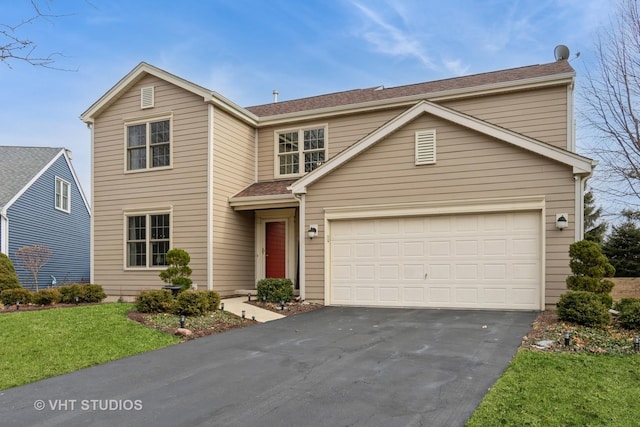 front facade featuring a garage and a front lawn