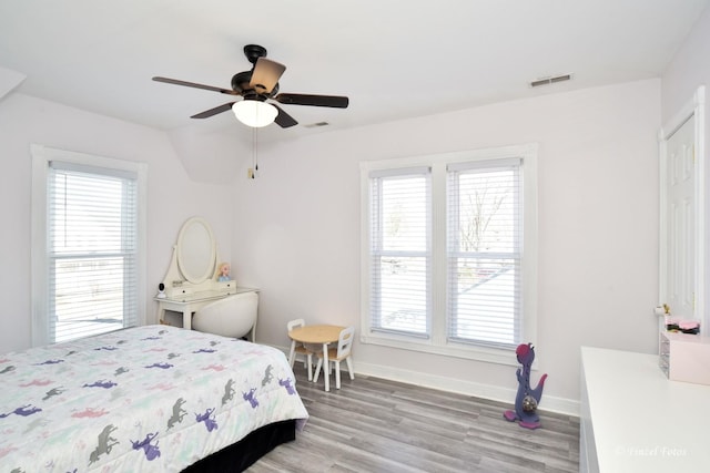 bedroom with hardwood / wood-style flooring, ceiling fan, and vaulted ceiling