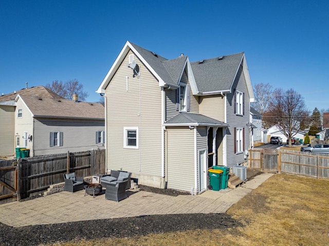 back of property with cooling unit, an outdoor living space, and a patio