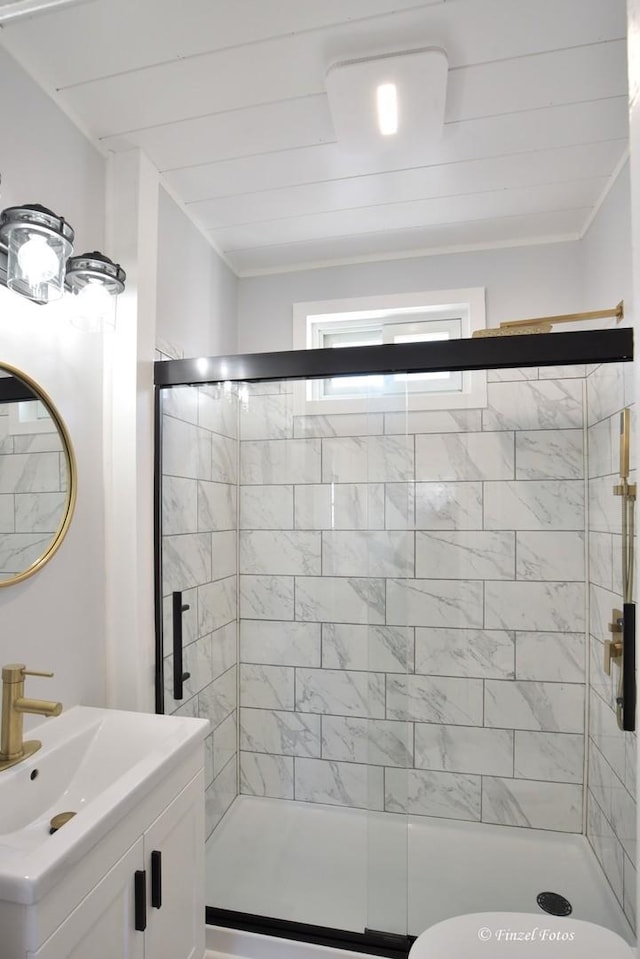 bathroom featuring toilet, a shower with shower door, wood ceiling, ornamental molding, and vanity