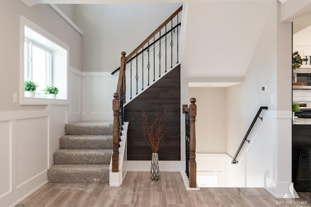 staircase with hardwood / wood-style flooring