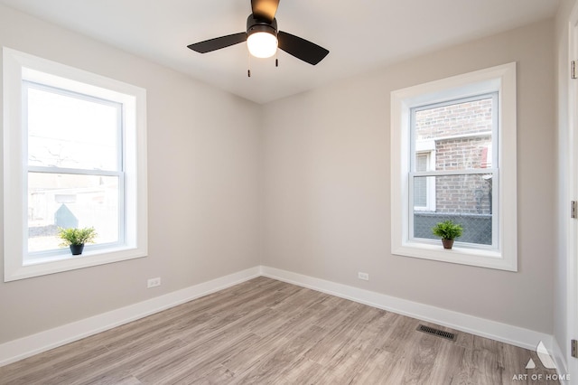 spare room featuring ceiling fan, plenty of natural light, and light hardwood / wood-style floors