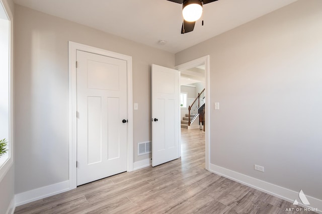 unfurnished bedroom with light hardwood / wood-style floors and ceiling fan