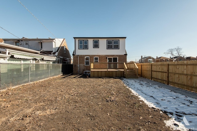 rear view of property featuring a deck