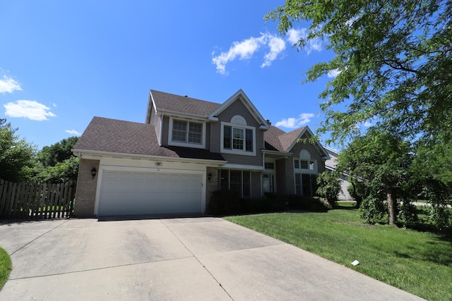 view of front of property with a garage and a front lawn