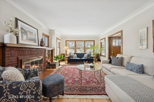 living room with a fireplace, ornamental molding, and wood finished floors