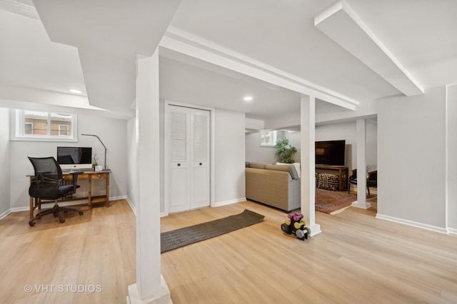 workout area featuring light wood-style flooring, baseboards, and recessed lighting