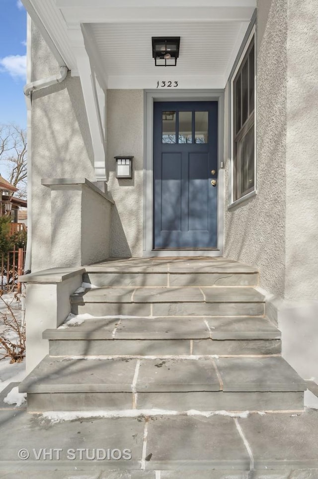 property entrance featuring stucco siding