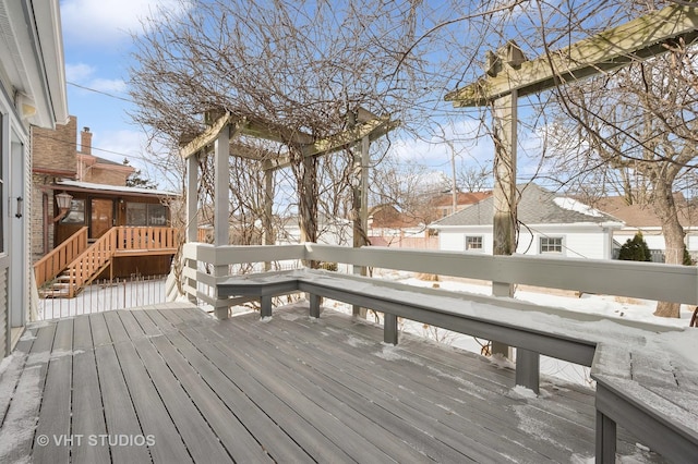 snow covered deck with a sunroom