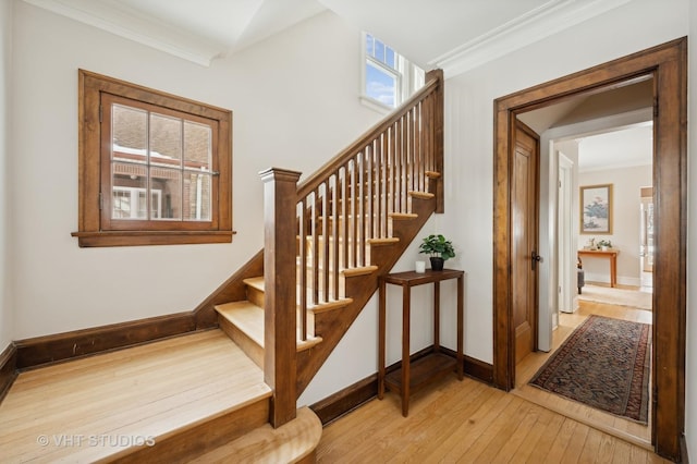 stairs featuring ornamental molding, baseboards, and hardwood / wood-style flooring