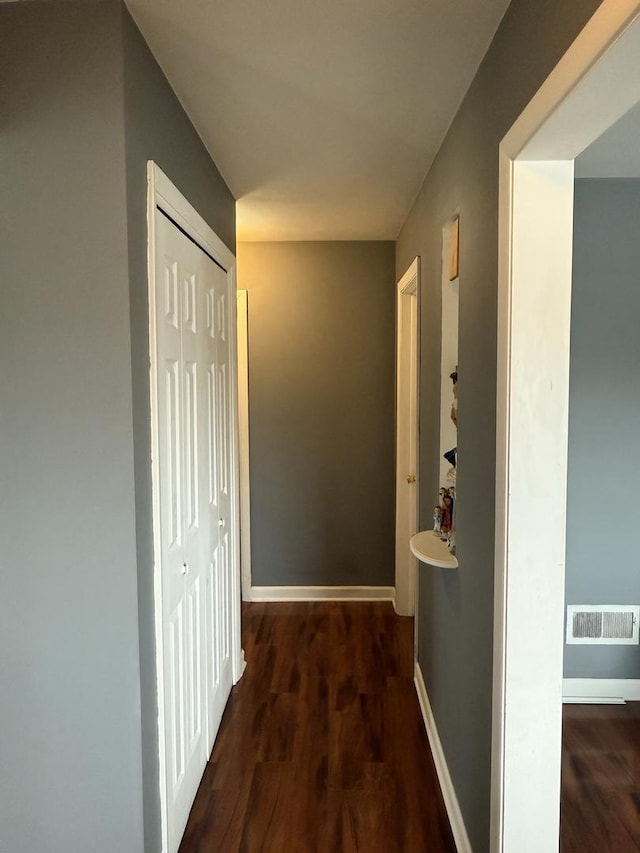 corridor featuring dark hardwood / wood-style floors