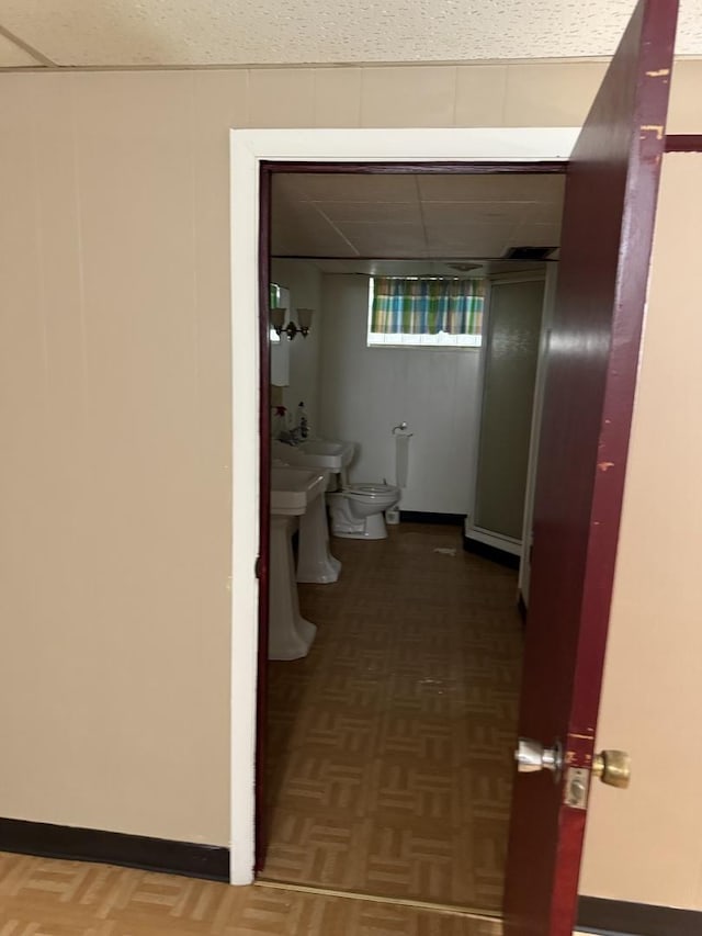 interior space with a bidet, parquet floors, and toilet