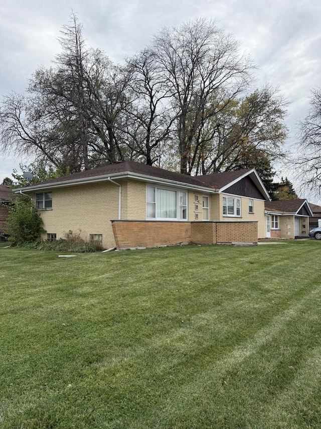 rear view of property with a lawn