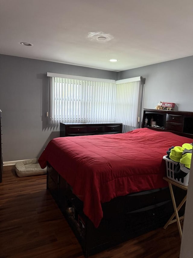 bedroom with dark wood-type flooring