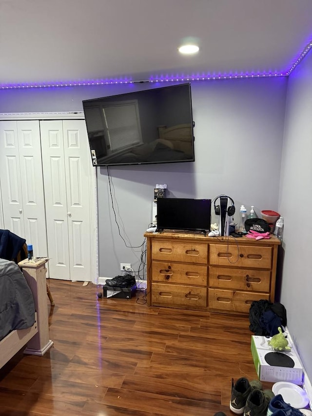 bedroom featuring dark hardwood / wood-style flooring and a closet