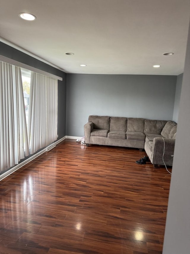 unfurnished living room featuring dark wood-type flooring