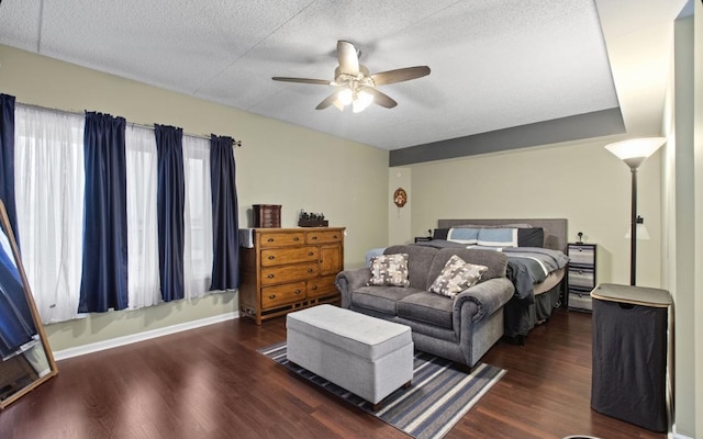 bedroom with a textured ceiling, ceiling fan, wood finished floors, and baseboards