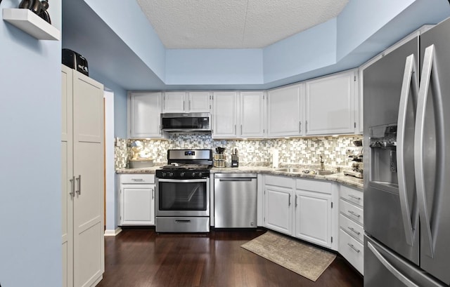 kitchen with white cabinetry, appliances with stainless steel finishes, and decorative backsplash